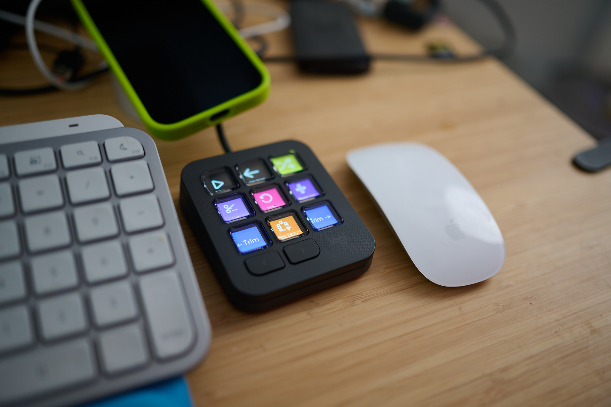 The Logitech MX Creative Console sitting next to a keyboard.