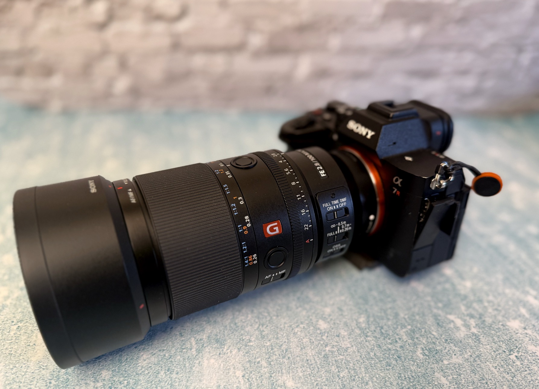 Sony 100mm macro on a blue table with white background