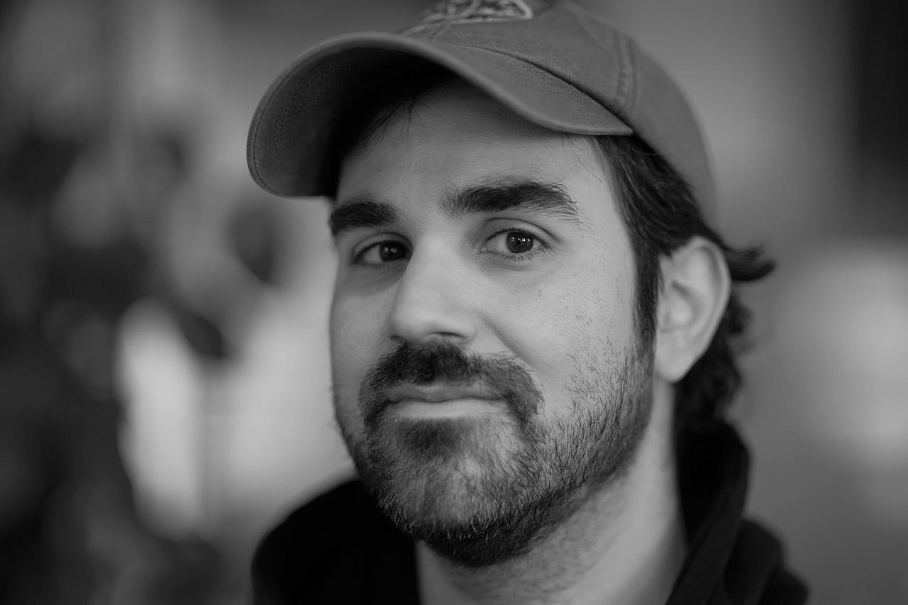 A portrait of a man in a baseball hat.