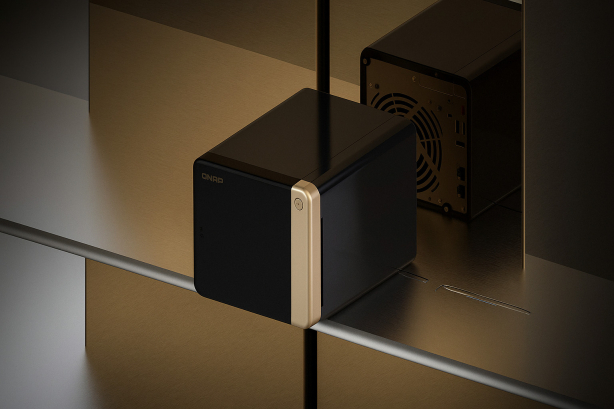 QNAP TS-464 2.5GbE NAS device in black and gold finish placed on a metallic shelf with another NAS unit in the background.